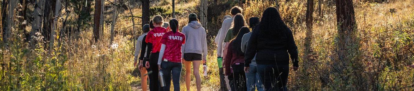 students hiking in woods